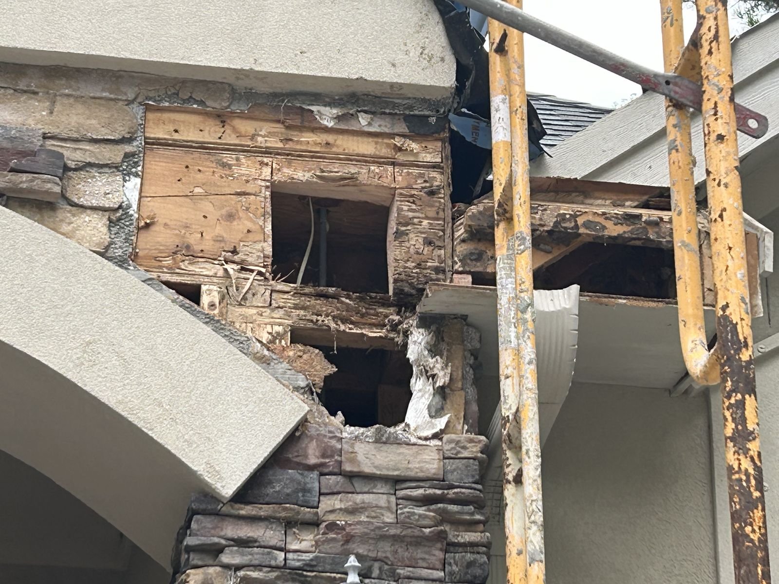 Rotted framing exposed behind stone veneer before repair by Burson Construction, Bluffton SC